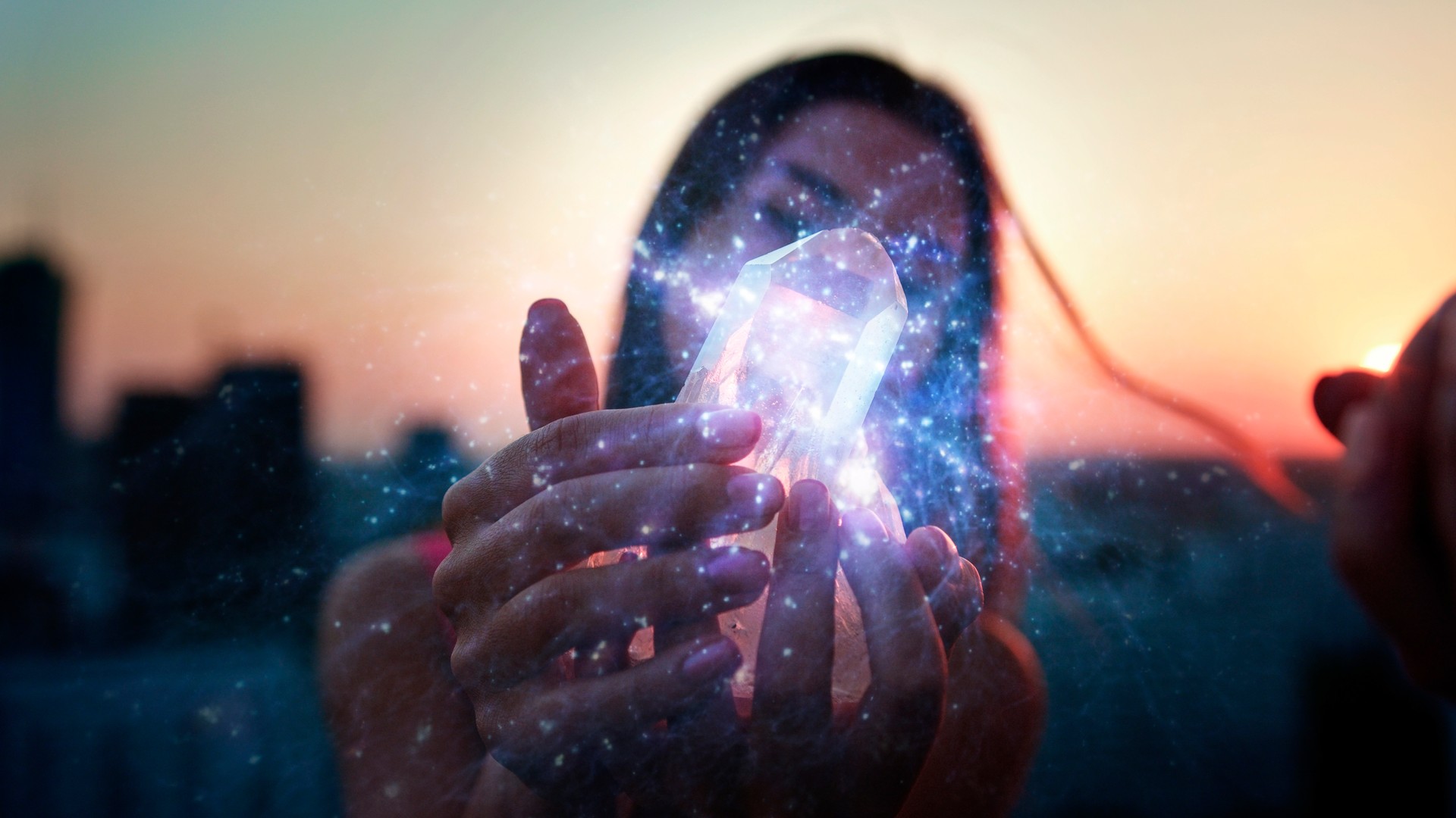 Crystal healing. Woman on a rooftop with city panorama. Magical meditation